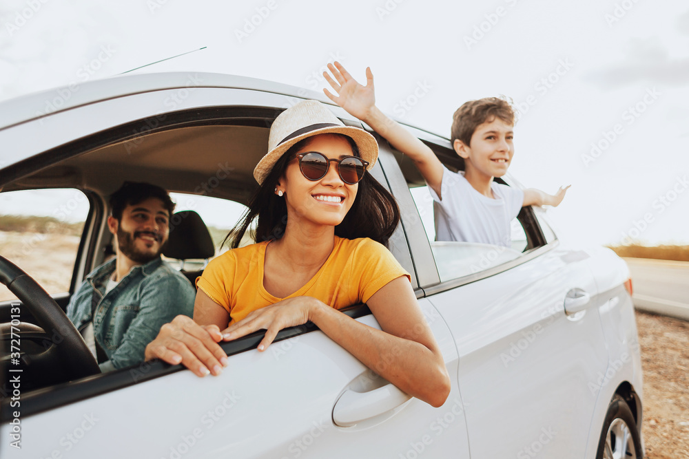 Family enjoying a sunny car ride